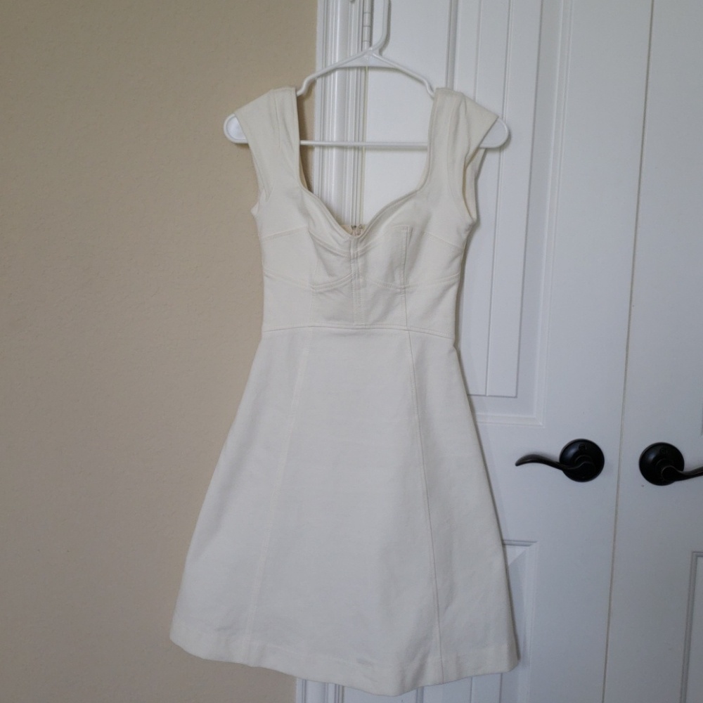 White dress, deep cut for cleavage. Good conditon